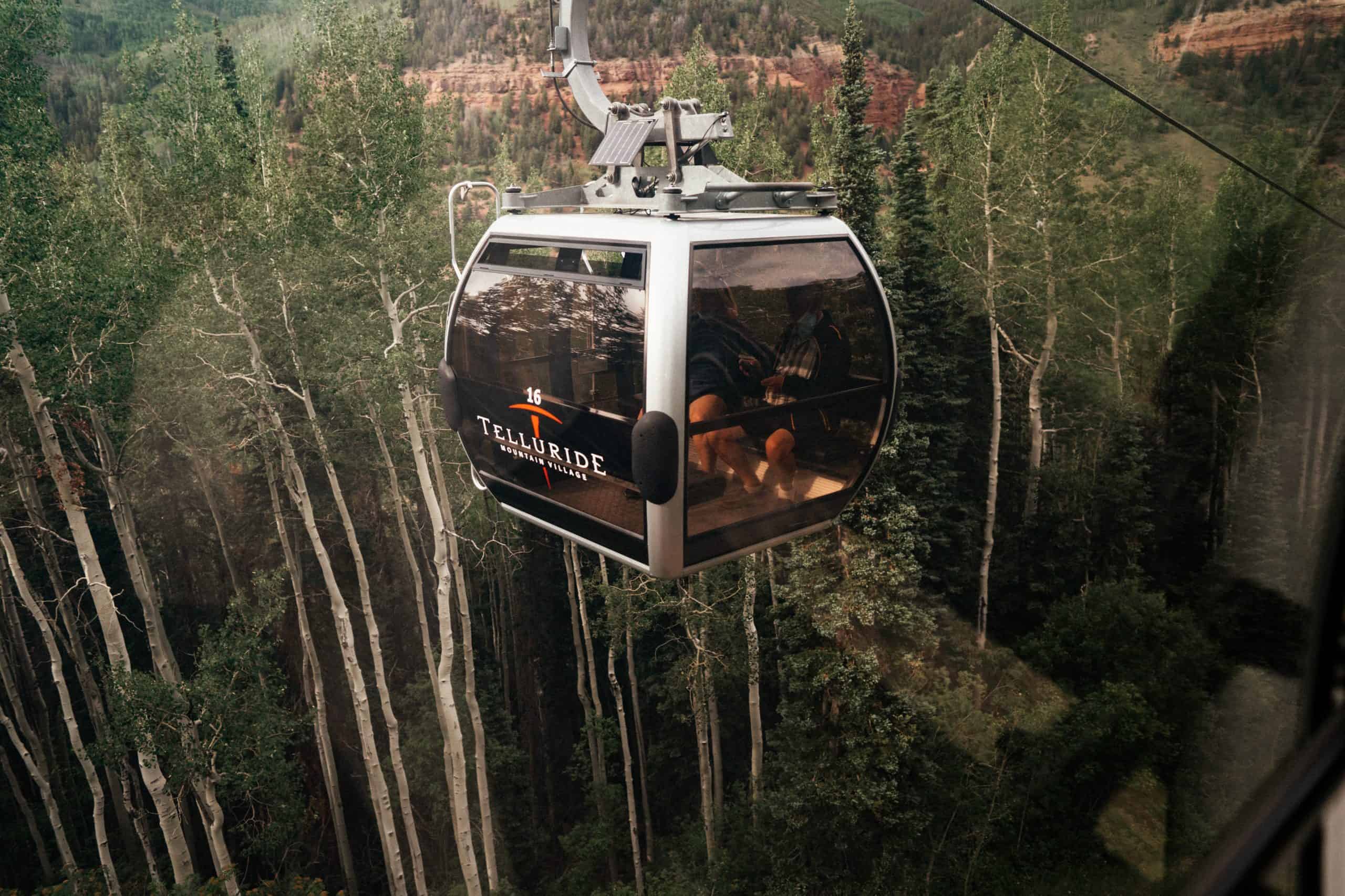 couple taking the gondola to the top of Telluride mountain for their elopement