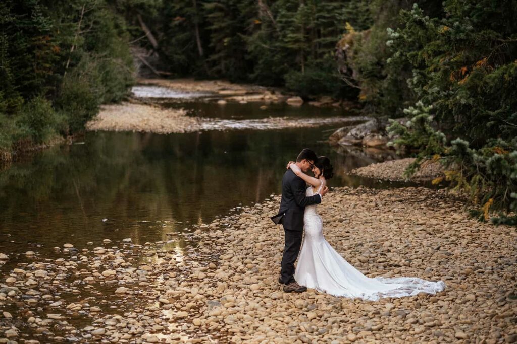 couple next to river at Colorado elopement