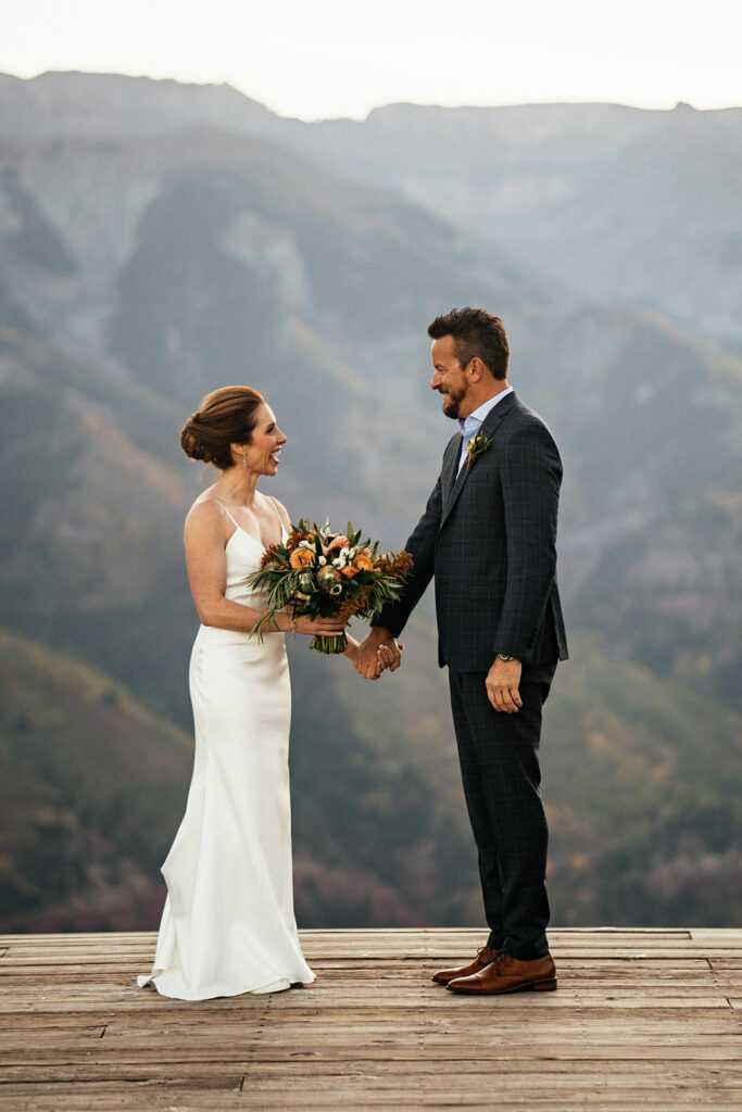 Bride and groom smiling at each other at San Sofia Overlook elopement in Telluride, Colorado