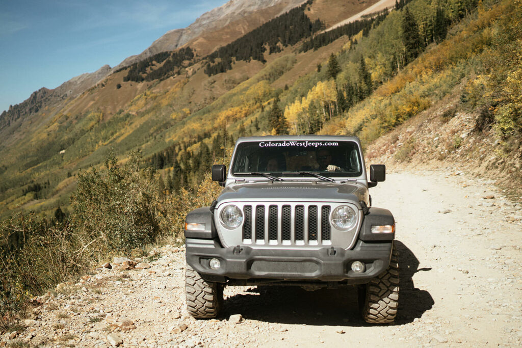 Jeep making way up narrow road on Ophir Pass at Telluride, Colorado elopement.