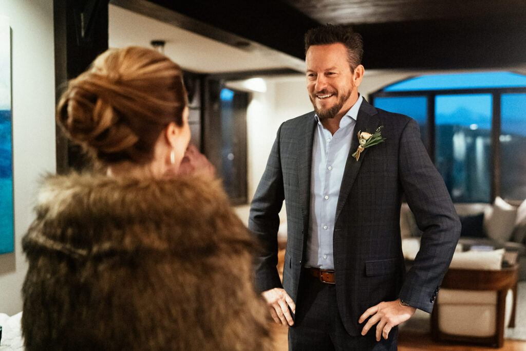 Groom smiling at bride after first look at hotel in Telluride, Colorado.