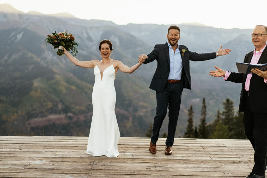 Bride and groom celebrate after ceremony at San Sofia Overlook elopement in Telluride.
